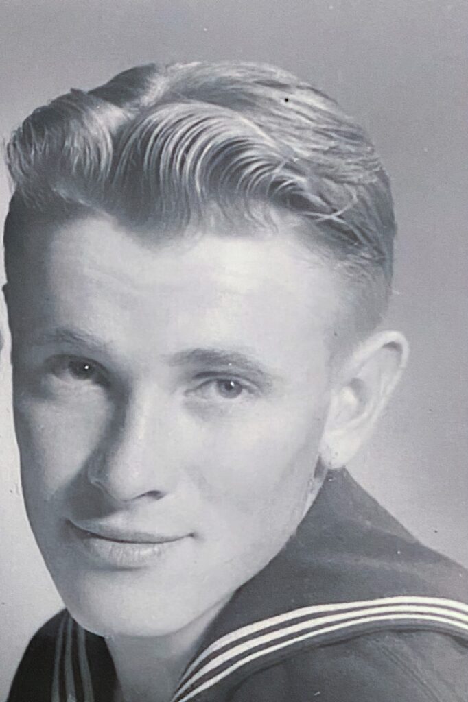 Black-and-white studio portrait of Harry Wayne Schmoll as a young man, in uniform